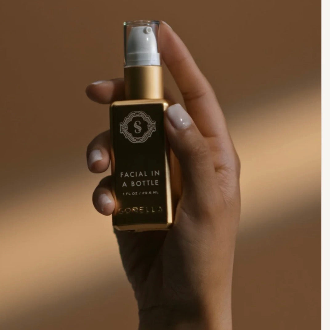 Sorella Facial in a Bottle nighttime serum held in hand